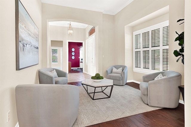 5405 Enfield Dr, Richardson, TX 75082 - living room featuring arched walkways, wood finished floors, and ornamental molding