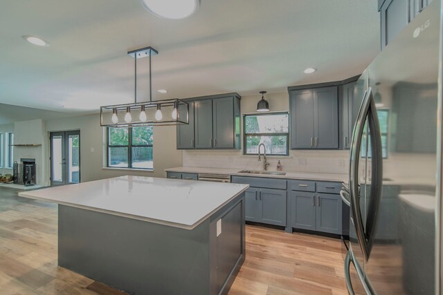 5209 Cordova Ave, Fort Worth, TX 76132 - kitchen featuring freestanding refrigerator, gray cabinets, light countertops, decorative backsplash, and recessed lighting