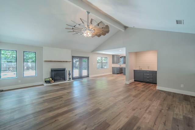 5209 Cordova Ave, Fort Worth, TX 76132 - unfurnished living room with ceiling fan, beamed ceiling, wood finished floors, a fireplace with raised hearth, and high vaulted ceiling