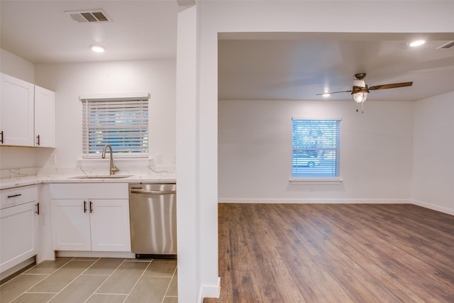 431 S Locust St, Mesquite, TX 75149 - kitchen with stainless steel dishwasher, light stone countertops, white cabinets, a ceiling fan, and light wood finished floors