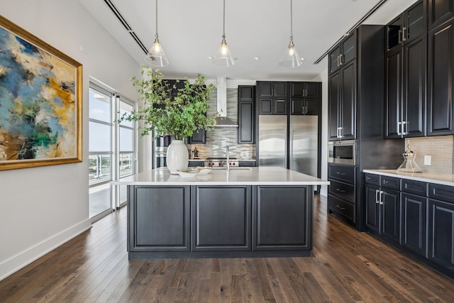 2800 Lakeside Pkwy Unit 1502, Flower Mound, TX 75022 - kitchen featuring wall chimney exhaust hood, dark cabinetry, and decorative backsplash