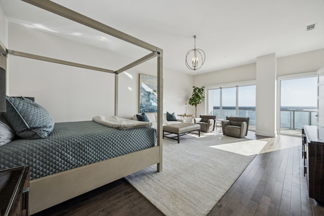 2800 Lakeside Pkwy Unit 1502, Flower Mound, TX 75022 - bedroom featuring dark wood finished floors, a chandelier, and a water view