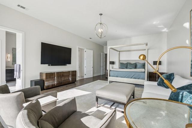 2800 Lakeside Pkwy Unit 1502, Flower Mound, TX 75022 - bedroom with a chandelier, wood finished floors, and connected bathroom