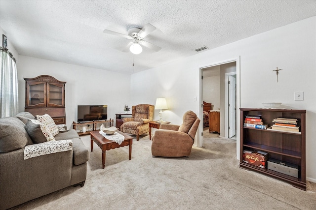 821 Sandpiper Dr, Denton, TX 76205 - carpeted living room featuring ceiling fan and a textured ceiling