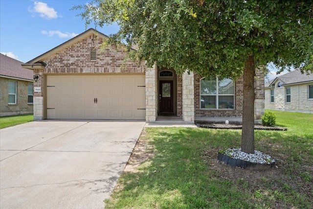 9444 Centennial Dr, Waco, TX 76708 - view of front of home featuring driveway, brick siding, a garage, and a front lawn