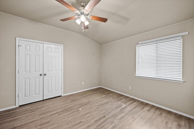 9444 Centennial Dr, Waco, TX 76708 - unfurnished bedroom with wood finished floors, a closet, ceiling fan, and lofted ceiling