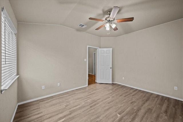 9444 Centennial Dr, Waco, TX 76708 - unfurnished bedroom with wood finished floors, vaulted ceiling, and a ceiling fan