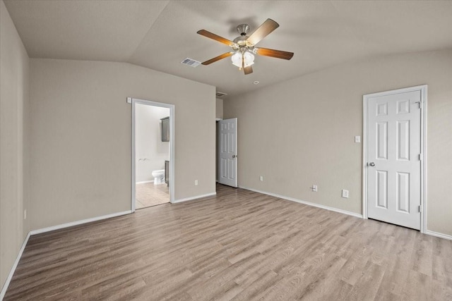 9444 Centennial Dr, Waco, TX 76708 - unfurnished bedroom with light wood finished floors, vaulted ceiling, ensuite bath, and a ceiling fan