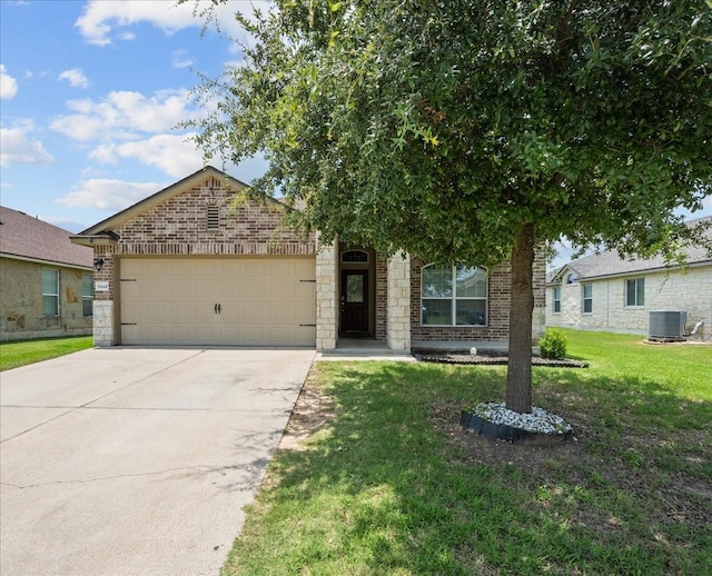 9444 Centennial Dr, Waco, TX 76708 - view of front of home with a garage, concrete driveway, a front yard, brick siding, and stone siding