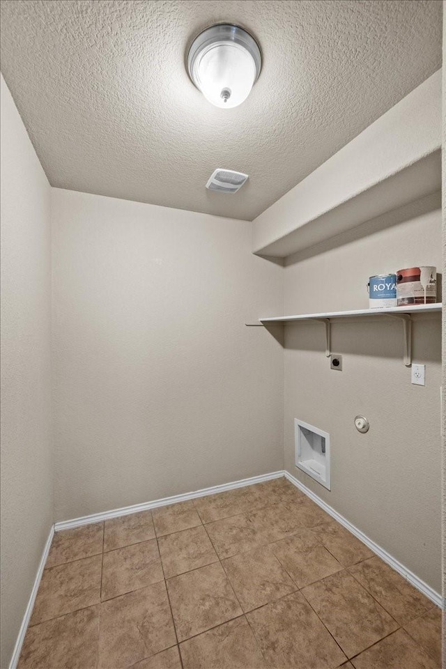 9444 Centennial Dr, Waco, TX 76708 - laundry room with electric dryer hookup, a textured ceiling, hookup for a gas dryer, and tile patterned flooring