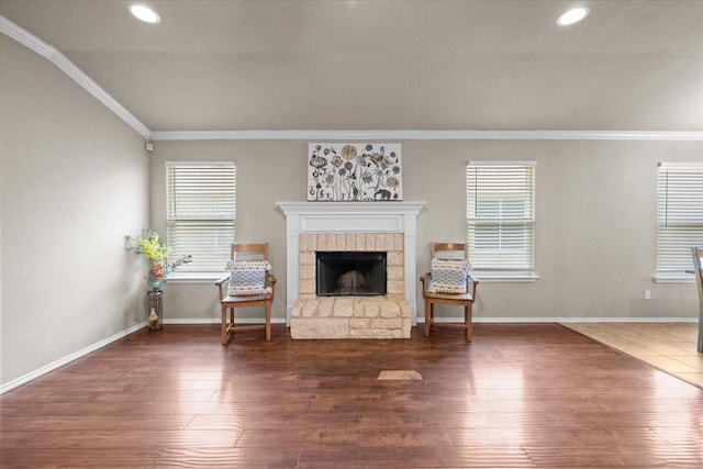 9444 Centennial Dr, Waco, TX 76708 - living area with ornamental molding, a stone fireplace, plenty of natural light, wood finished floors, and recessed lighting
