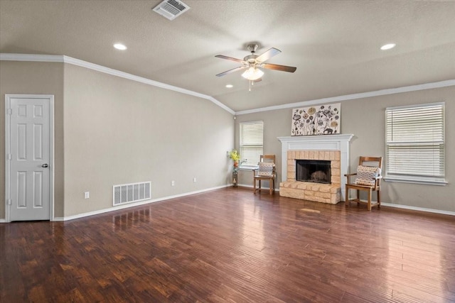 9444 Centennial Dr, Waco, TX 76708 - living area with a ceiling fan, healthy amount of natural light, a stone fireplace, wood finished floors, and ornamental molding