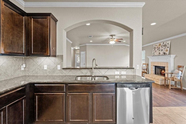 9444 Centennial Dr, Waco, TX 76708 - kitchen with dishwasher, ceiling fan, dark stone countertops, ornamental molding, and dark brown cabinets