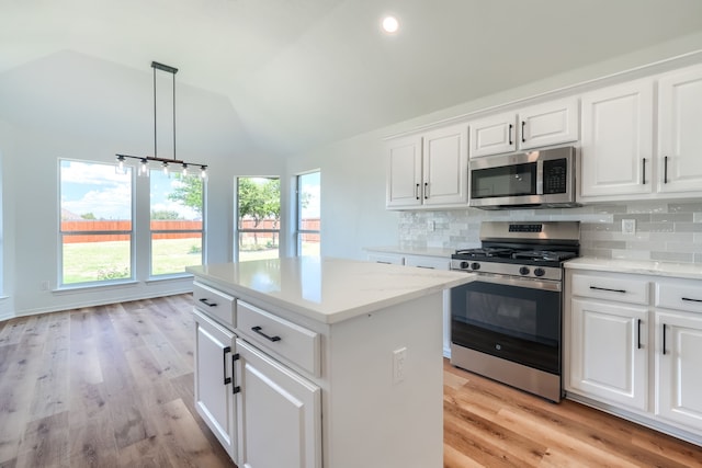 123 Rolling Spring Dr, Aledo, TX 76008 - kitchen with appliances with stainless steel finishes, vaulted ceiling, backsplash, healthy amount of natural light, and light wood-style floors