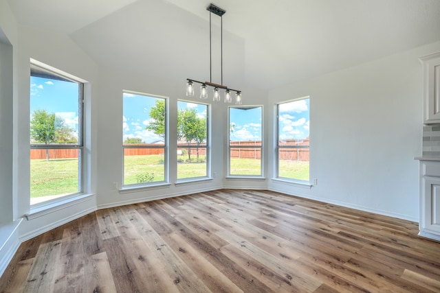 123 Rolling Spring Dr, Aledo, TX 76008 - unfurnished dining area with lofted ceiling and wood finished floors