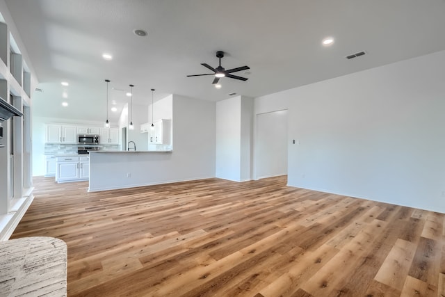 123 Rolling Spring Dr, Aledo, TX 76008 - unfurnished living room with a ceiling fan, light wood finished floors, and recessed lighting