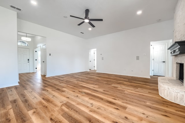 123 Rolling Spring Dr, Aledo, TX 76008 - unfurnished living room featuring ceiling fan, light wood-style floors, and a large fireplace