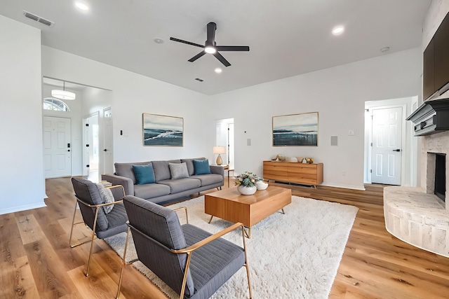 123 Rolling Spring Dr, Aledo, TX 76008 - living area featuring a ceiling fan, light wood-style flooring, recessed lighting, and a fireplace with raised hearth