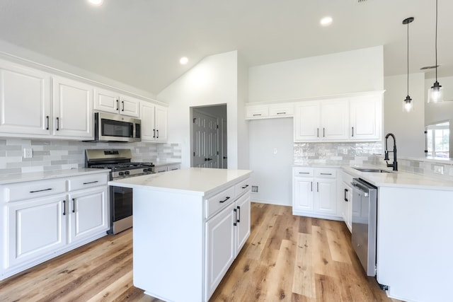 123 Rolling Spring Dr, Aledo, TX 76008 - kitchen featuring appliances with stainless steel finishes, decorative backsplash, vaulted ceiling, light countertops, and white cabinets