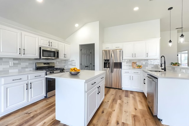 123 Rolling Spring Dr, Aledo, TX 76008 - kitchen with stainless steel appliances, tasteful backsplash, vaulted ceiling, light countertops, and a center island