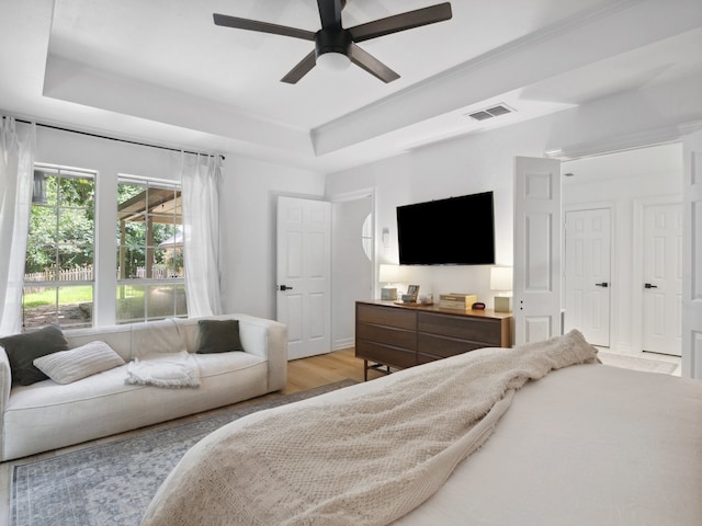 915 Slippery Elm Dr, Ovilla, TX 75154 - bedroom featuring a raised ceiling, wood finished floors, and a ceiling fan