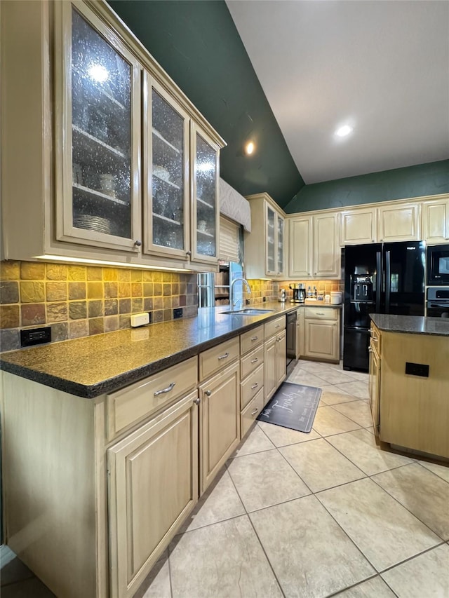 2629 Valley Creek Trl, Mckinney, TX 75072 - kitchen with black appliances, decorative backsplash, glass insert cabinets, lofted ceiling, and cream cabinetry