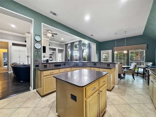 2629 Valley Creek Trl, Mckinney, TX 75072 - kitchen featuring a kitchen island, light tile patterned flooring, a ceiling fan, hanging light fixtures, and a peninsula
