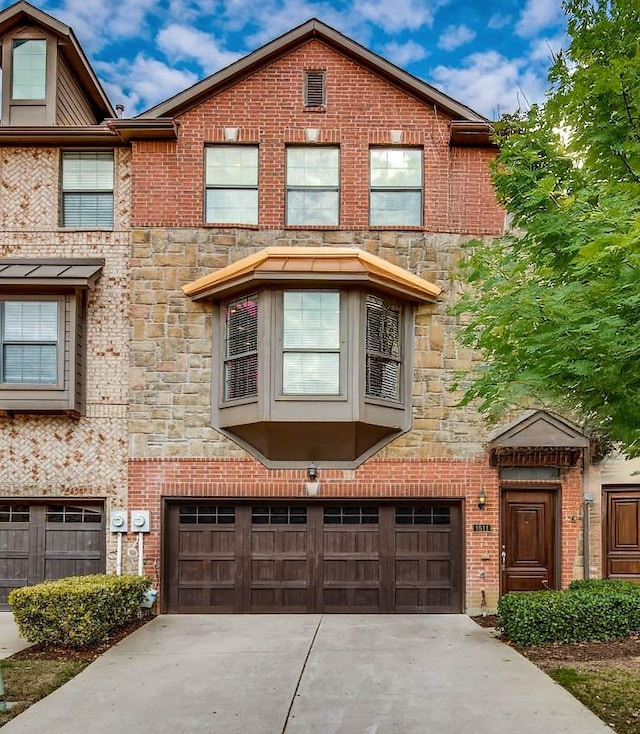 1511 Biltmore Ln, Irving, TX 75063 - view of property featuring a garage, stone siding, and concrete driveway