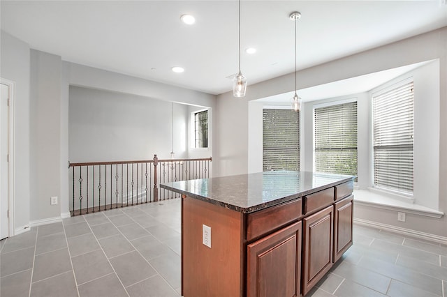 1511 Biltmore Ln, Irving, TX 75063 - kitchen with light tile patterned floors, dark stone countertops, decorative light fixtures, a center island, and recessed lighting
