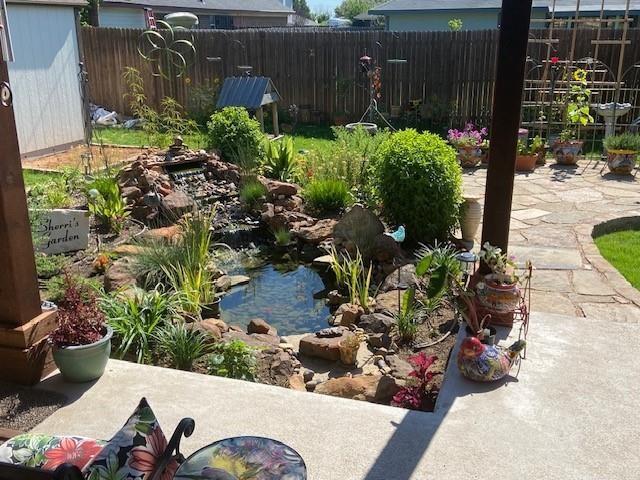 108 Gateway Dr, Alvarado, TX 76009 - view of yard with a garden pond and an outbuilding