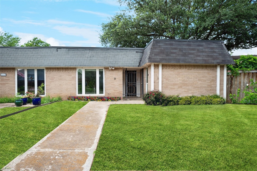 10517 Egret Ln, Dallas, TX 75230 - view of front facade featuring brick siding, mansard roof, and roof with shingles