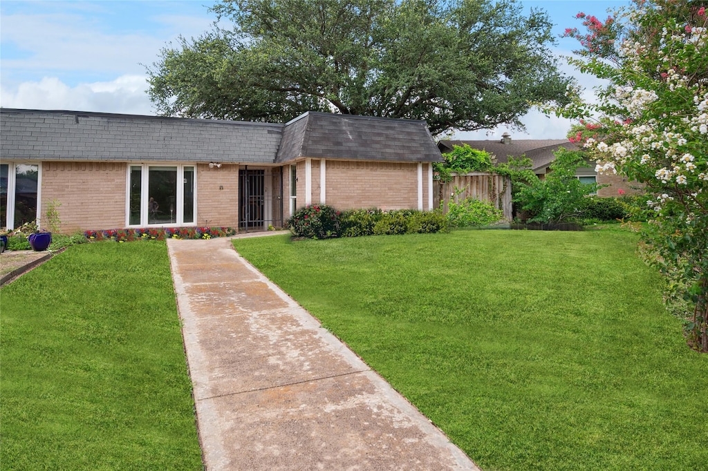 10517 Egret Ln, Dallas, TX 75230 - view of front of house with mansard roof, brick siding, and roof with shingles