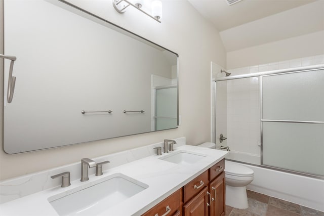 1017 Nickerson Ln, Plano, TX 75094 - full bathroom with double vanity, combined bath / shower with glass door, stone finish flooring, and lofted ceiling