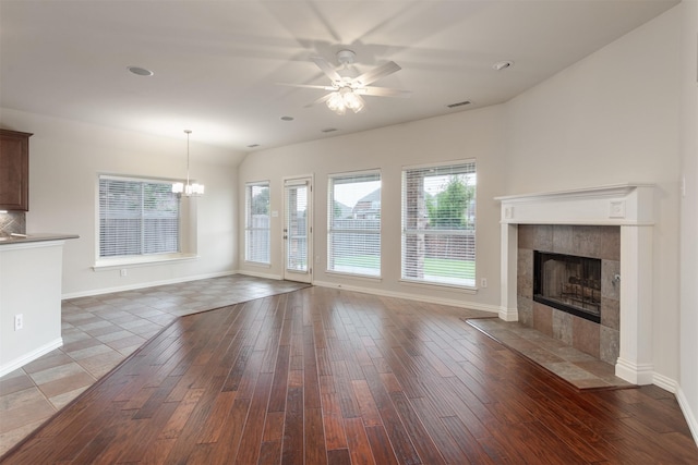 1017 Nickerson Ln, Plano, TX 75094 - unfurnished living room featuring ceiling fan, a tile fireplace, plenty of natural light, wood finished floors, and lofted ceiling