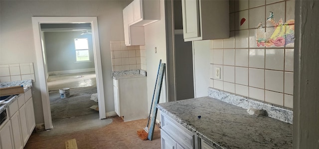 940 W 7th St, Dallas, TX 75208 - kitchen with decorative backsplash, light stone countertops, light colored carpet, and white cabinetry