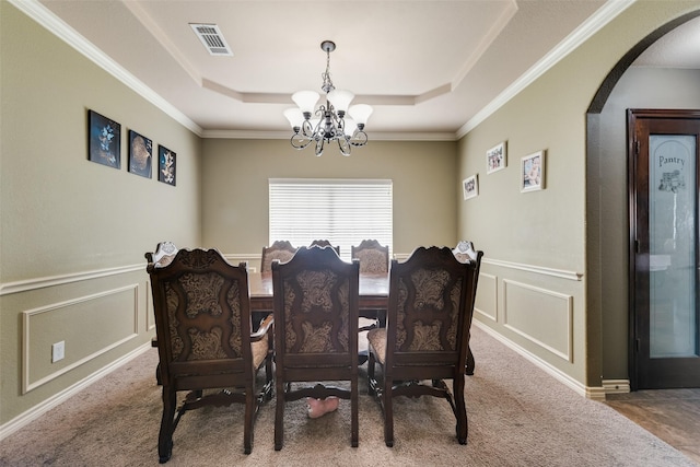 461 Running Water Trl, Fort Worth, TX 76131 - carpeted dining space featuring a chandelier, a raised ceiling, arched walkways, a decorative wall, and ornamental molding