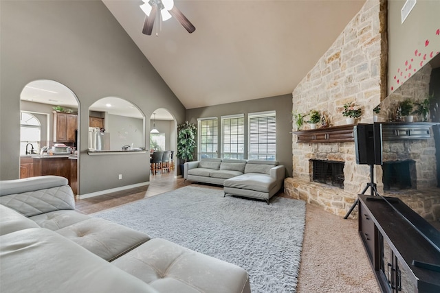 461 Running Water Trl, Fort Worth, TX 76131 - living room featuring high vaulted ceiling, a stone fireplace, arched walkways, ceiling fan, and healthy amount of natural light