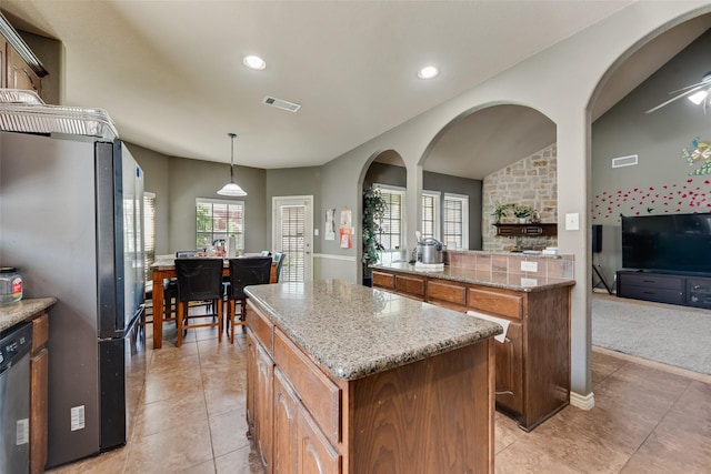 461 Running Water Trl, Fort Worth, TX 76131 - kitchen featuring stainless steel appliances, a center island, recessed lighting, arched walkways, and light stone counters