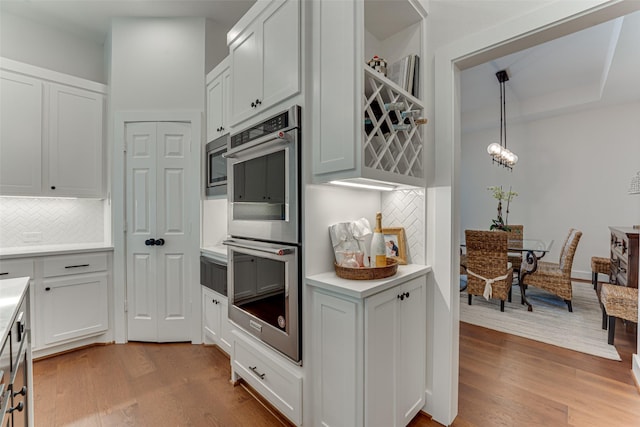 4508 Crystal Mountain Dr, Richardson, TX 75082 - kitchen featuring stainless steel appliances, tasteful backsplash, wood finished floors, and light countertops