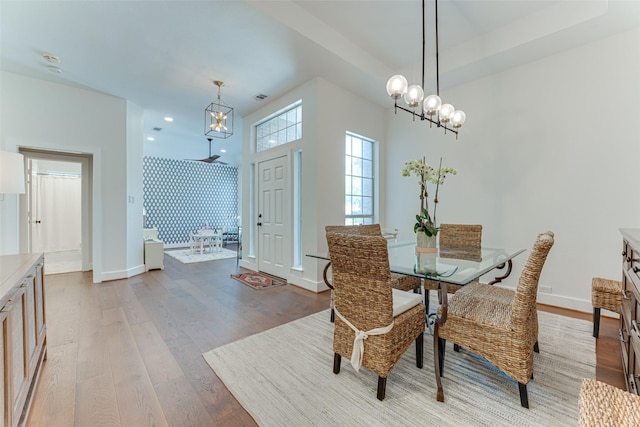 4508 Crystal Mountain Dr, Richardson, TX 75082 - dining room with a chandelier, light wood-style floors, wallpapered walls, and recessed lighting