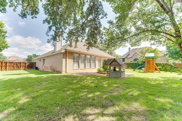 4508 Crystal Mountain Dr, Richardson, TX 75082 - back of house featuring a playground, brick siding, a fenced backyard, and a chimney