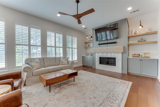 4508 Crystal Mountain Dr, Richardson, TX 75082 - living area featuring a ceiling fan, wood finished floors, a glass covered fireplace, and recessed lighting