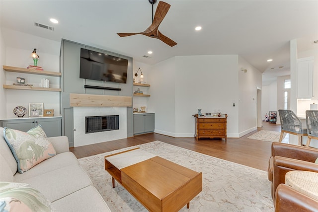 4508 Crystal Mountain Dr, Richardson, TX 75082 - living room featuring wood finished floors, a ceiling fan, a fireplace, and recessed lighting