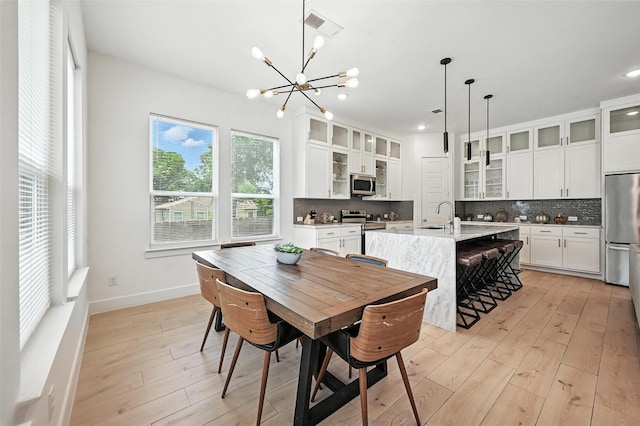 1338 E Kiest Blvd, Dallas, TX 75216 - dining room with a chandelier, light wood-style floors, and recessed lighting