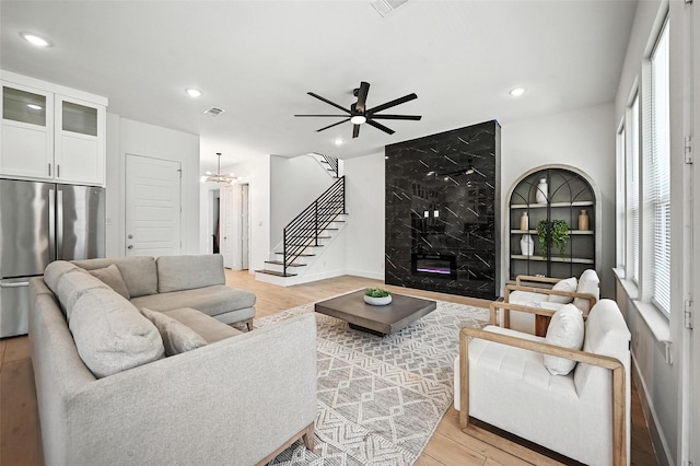 1338 E Kiest Blvd, Dallas, TX 75216 - living area featuring light wood finished floors, ceiling fan, recessed lighting, a fireplace, and a chandelier