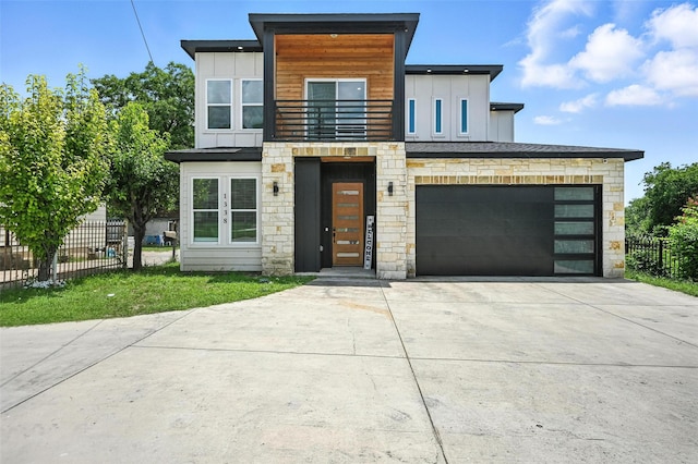 1338 E Kiest Blvd, Dallas, TX 75216 - contemporary house with a balcony, concrete driveway, stone siding, and board and batten siding