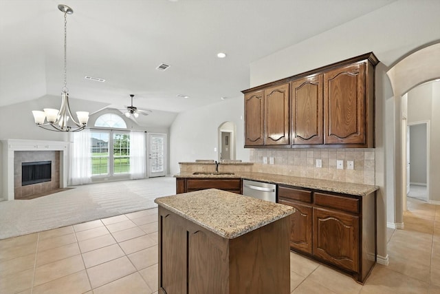 11412 Grapeleaf Dr, Fort Worth, TX 76244 - kitchen with arched walkways, stainless steel dishwasher, lofted ceiling, ceiling fan, and light tile patterned floors