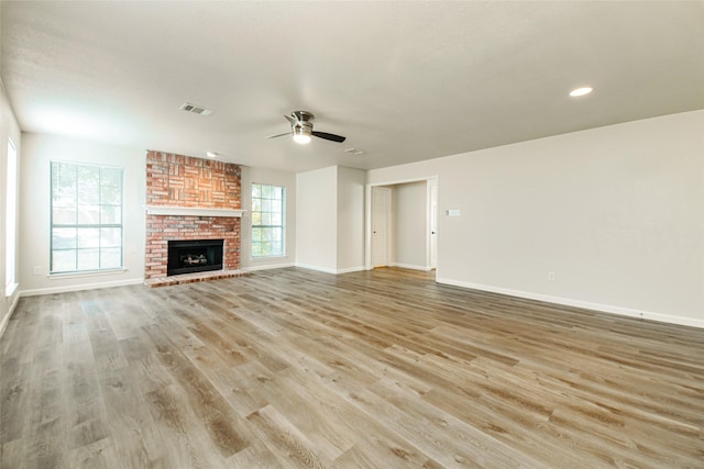 813 Ridgemont Dr, Allen, TX 75002 - unfurnished living room featuring light wood-type flooring, ceiling fan, a fireplace, and recessed lighting