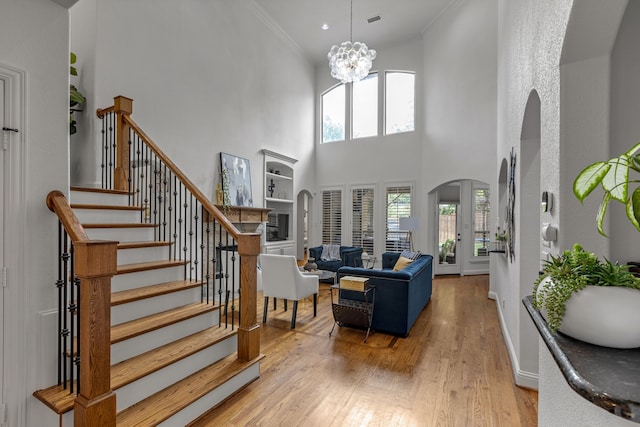 2248 Forest Hollow Park, Dallas, TX 75228 - living area featuring a towering ceiling, stairway, arched walkways, healthy amount of natural light, and light wood finished floors