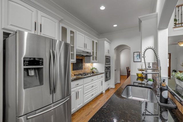 2248 Forest Hollow Park, Dallas, TX 75228 - kitchen with appliances with stainless steel finishes, arched walkways, under cabinet range hood, crown molding, and white cabinets
